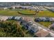 An aerial view of the home and neighborhood featuring baseball fields nearby at 8309 Park Cliff Way, Orlando, FL 32836