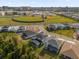 An aerial view of the home and neighborhood featuring baseball fields nearby at 8309 Park Cliff Way, Orlando, FL 32836