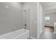 Bathroom featuring a white bathtub and shower with tiled walls at 8309 Park Cliff Way, Orlando, FL 32836