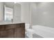 Modern bathroom featuring a dark wood vanity, white toilet, and a shower-tub combination at 8309 Park Cliff Way, Orlando, FL 32836