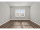 Bedroom with hardwood floors and bright natural light streaming through the double windows at 8309 Park Cliff Way, Orlando, FL 32836