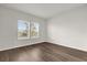 Bright room featuring hardwood floors, neutral walls, and natural light from double windows at 8309 Park Cliff Way, Orlando, FL 32836