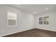 A bright bedroom featuring hardwood floors and windows with blinds providing natural light at 8309 Park Cliff Way, Orlando, FL 32836