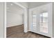 Elegant entryway featuring hardwood floors and decorative glass front doors and clear view into the house at 8309 Park Cliff Way, Orlando, FL 32836