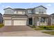 Beautiful two-story home with a three-car garage and stone accents at 8309 Park Cliff Way, Orlando, FL 32836