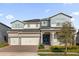 Attractive home with a blue-painted accent on the upper level and a three-car garage at 8309 Park Cliff Way, Orlando, FL 32836