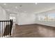 Large, naturally lit upstairs living room featuring wood flooring, multiple windows, and an open staircase at 8309 Park Cliff Way, Orlando, FL 32836