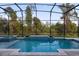 Enclosed pool area with water feature and lush green scenery at 8309 Park Cliff Way, Orlando, FL 32836