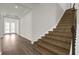 Elegant staircase with mosaic tile accents and hardwood floors at 8309 Park Cliff Way, Orlando, FL 32836