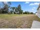 Large grassy backyard featuring mature trees, with ample space for recreation at 855 S Hancock Dr, Deltona, FL 32725