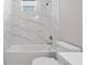 Stylish bathroom featuring a marble tiled shower over tub and modern fixtures at 855 S Hancock Dr, Deltona, FL 32725