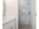 Bathroom with a walk-in shower featuring marble tile and a hexagon-tiled floor at 855 S Hancock Dr, Deltona, FL 32725