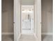 Hallway view of the bathroom with double sinks and white cabinets at 855 S Hancock Dr, Deltona, FL 32725