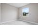 A well-lit bedroom with marble flooring and a bright window looking out onto the backyard at 855 S Hancock Dr, Deltona, FL 32725