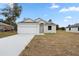 Charming single-story home with a two-car garage and neutral-colored stucco exterior and well-maintained lawn at 855 S Hancock Dr, Deltona, FL 32725