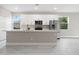 Modern kitchen with white cabinets, stainless steel appliances, and marble-look tile floors at 855 S Hancock Dr, Deltona, FL 32725