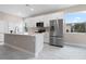 Modern kitchen featuring white cabinetry, stainless steel appliances, and marble-look tile floors at 855 S Hancock Dr, Deltona, FL 32725