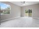 Living room featuring bright lighting, tile floors, large windows, and a sliding glass door at 855 S Hancock Dr, Deltona, FL 32725