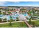 Expansive aerial view of the community, showcasing the pool, water park, and lush landscaping at 8920 Rhodes St, Kissimmee, FL 34747