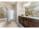 Bathroom featuring a large vanity with dual sinks and a walk-in shower at 8920 Rhodes St, Kissimmee, FL 34747
