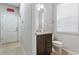 Bathroom with a vanity, drawers, granite countertop, toilet, and window at 8920 Rhodes St, Kissimmee, FL 34747