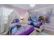 Themed bedroom features twin beds, whimsical canopies, and Frozen-themed wallpaper and bedding at 8920 Rhodes St, Kissimmee, FL 34747