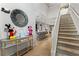 View of the staircase and foyer featuring a decorative mirror, chandelier and tile flooring at 8920 Rhodes St, Kissimmee, FL 34747