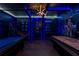 Bright game room with blue lighting and custom wall decor and pool and air hockey tables at 8920 Rhodes St, Kissimmee, FL 34747