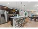Open kitchen featuring a large island with seating and stainless steel appliances at 8920 Rhodes St, Kissimmee, FL 34747