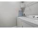 Functional laundry room features a washer, dryer, and storage shelf for supplies at 8920 Rhodes St, Kissimmee, FL 34747