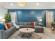 Modern living room boasts a blue accent wall, stylish decor, and comfortable seating, creating an inviting space at 8920 Rhodes St, Kissimmee, FL 34747