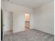 Spacious bedroom with plush carpeting and an ensuite bathroom in a bright and airy space at 9157 Harris Hawk Dr, Leesburg, FL 34788