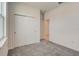 Neutral bedroom featuring neutral carpeting and a closet with sliding doors at 9157 Harris Hawk Dr, Leesburg, FL 34788