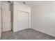 Neutral bedroom featuring neutral carpeting and a closet with sliding doors at 9157 Harris Hawk Dr, Leesburg, FL 34788