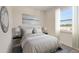 Cozy bedroom featuring a comfortable bed, neutral color scheme, and a window with natural light at 9157 Harris Hawk Dr, Leesburg, FL 34788