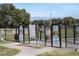 Fenced dog park with separate areas for small and large dogs, providing a safe play space at 9157 Harris Hawk Dr, Leesburg, FL 34788