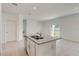 Island sink and granite countertop in an open concept kitchen and dining area at 9157 Harris Hawk Dr, Leesburg, FL 34788