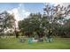 Large backyard firepit surrounded by comfortable Adirondack chairs at 9919 Hickory Hollow Rd, Leesburg, FL 34788