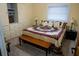 Comfortable bedroom featuring a quilted bedspread and a spacious wardrobe at 9919 Hickory Hollow Rd, Leesburg, FL 34788