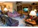 Cozy living room featuring built-in shelving, a TV, and comfortable seating at 9919 Hickory Hollow Rd, Leesburg, FL 34788