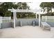 Outdoor shower area features a pergola and comfortable lounge chairs at 9919 Hickory Hollow Rd, Leesburg, FL 34788