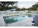 Beautiful backyard pool is surrounded by a white picket fence at 9919 Hickory Hollow Rd, Leesburg, FL 34788