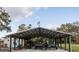 Large shed for parking equipment on a well-maintained homesite at 9919 Hickory Hollow Rd, Leesburg, FL 34788