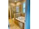 Bathroom featuring a soaking tub, glass-enclosed shower, and tiled floor at 2523 Econ Landing Blvd, Orlando, FL 32825