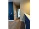 Carpeted hallway with blue accent wall and views into nearby rooms at 2523 Econ Landing Blvd, Orlando, FL 32825