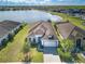 Beautiful aerial shot showcasing a home's lush landscaping and tranquil lake view at 113 Azure Mist Way, Daytona Beach, FL 32124