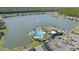 Aerial view of community, showcasing a large lake, pool, clubhouse, and green spaces at 113 Azure Mist Way, Daytona Beach, FL 32124