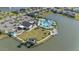 Aerial view of the community showcasing a pool, clubhouse, park, lake, and waterfront views at 113 Azure Mist Way, Daytona Beach, FL 32124