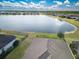Stunning aerial view of a home backing onto a serene lake with lush greenery and neighboring houses at 113 Azure Mist Way, Daytona Beach, FL 32124