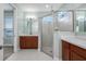 An en-suite bathroom features dual sinks, a large glass shower, and ceramic tile at 113 Azure Mist Way, Daytona Beach, FL 32124